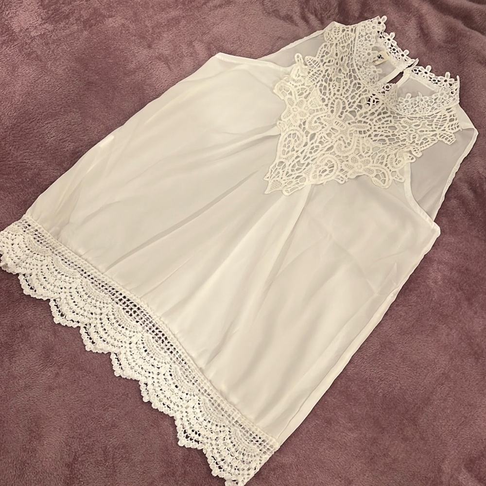White sheer sleeveless top.